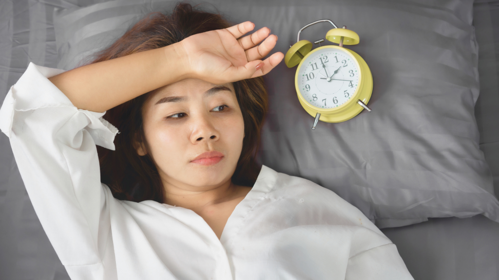 Woman lying down with clock overthinking